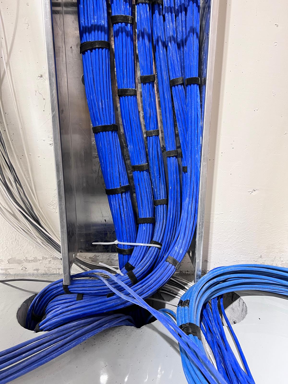 Ace Realm technicians neatly dressing Cat6A patch panel